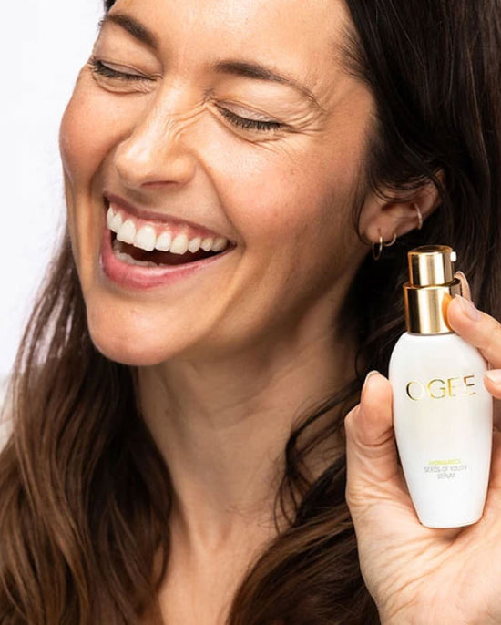 Smiling person holding OGEE serum