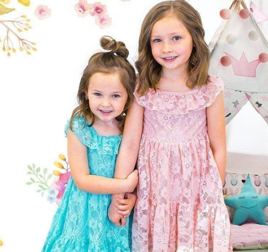 Two children wearing Sparkle in Pink dresses 