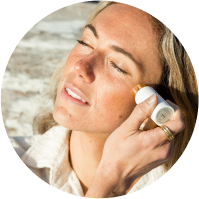 Woman applying ogee skincare product